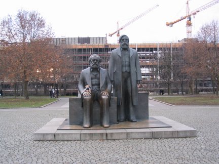 Jimby sitting on The Karl Marx and Engels statue